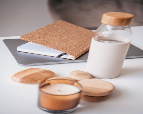 Reusable water bottle and a notebook on an office desk